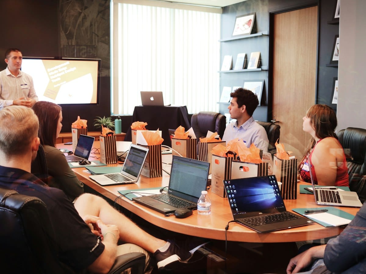 Colleagues reviewing work on a laptop