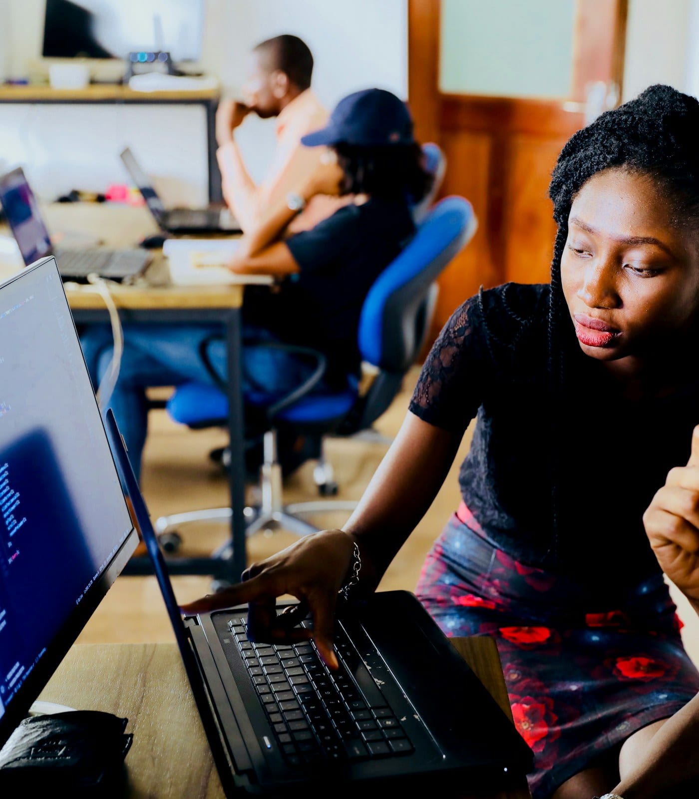 Software engineers reviewing an application on a large monitor in an office