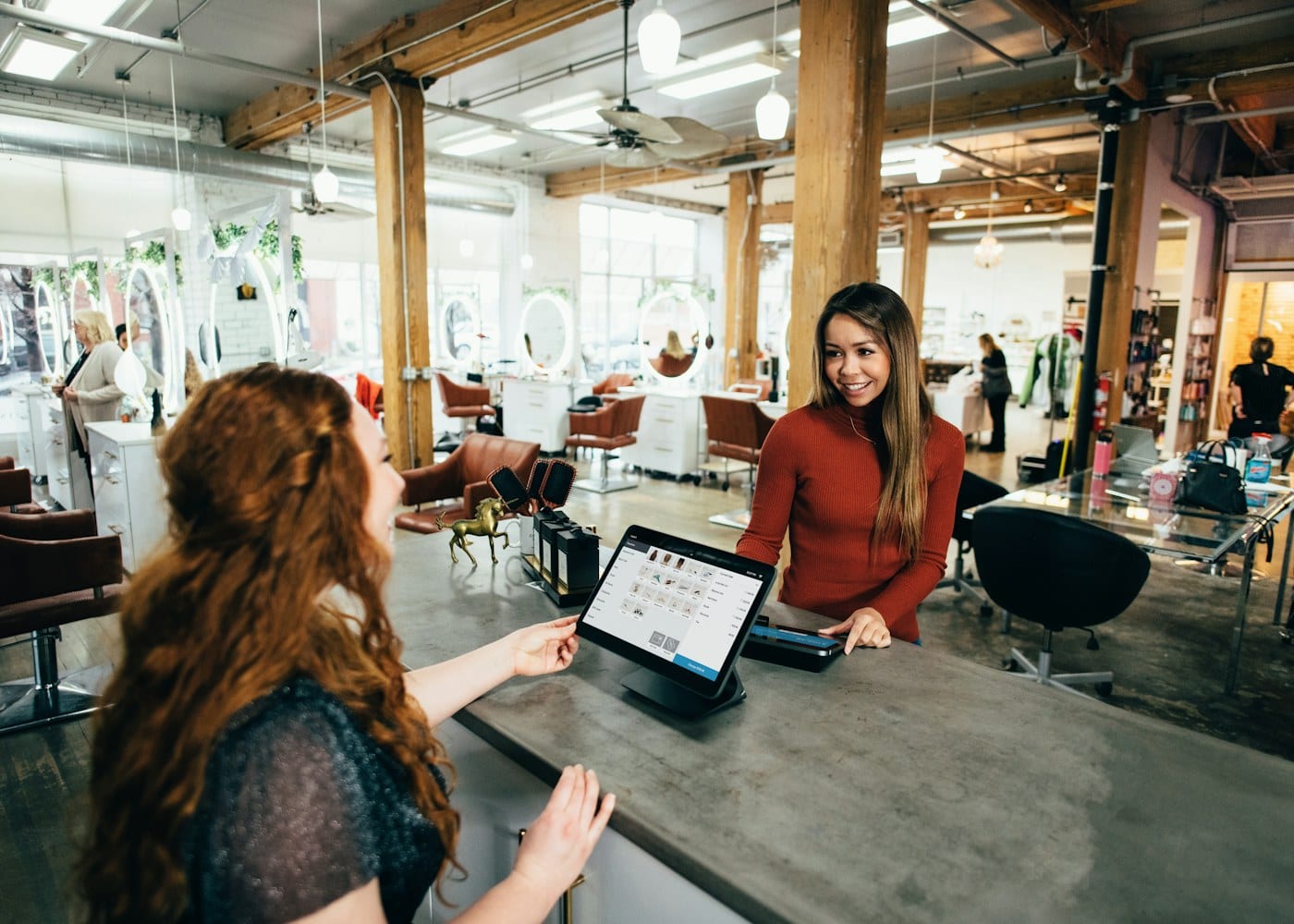 Cashier taking a card payment at a café counter
