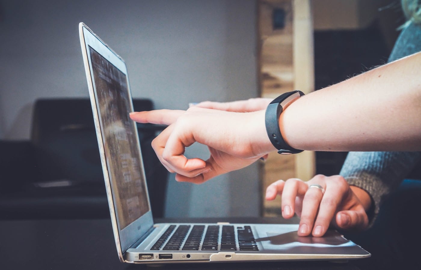 Developer holding a phone next to a laptop
