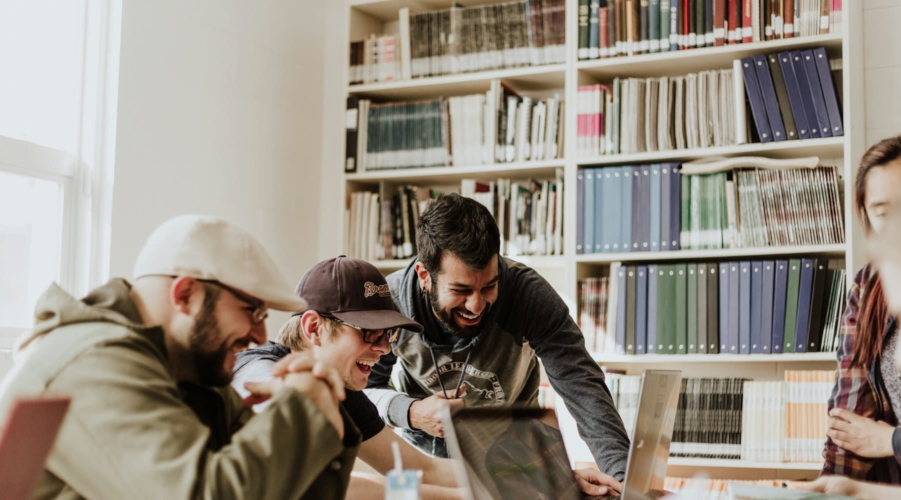 Colleagues talking around a table in an office