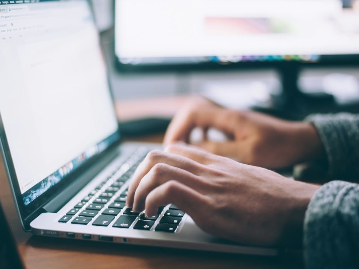 Person typing on a laptop at a desk